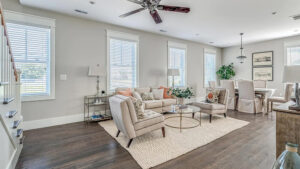 Hardwood floor living and dining room with staircase.